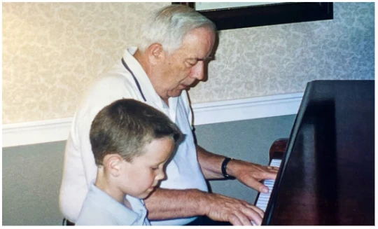 Lenny Hoyt at the piano with his grandson